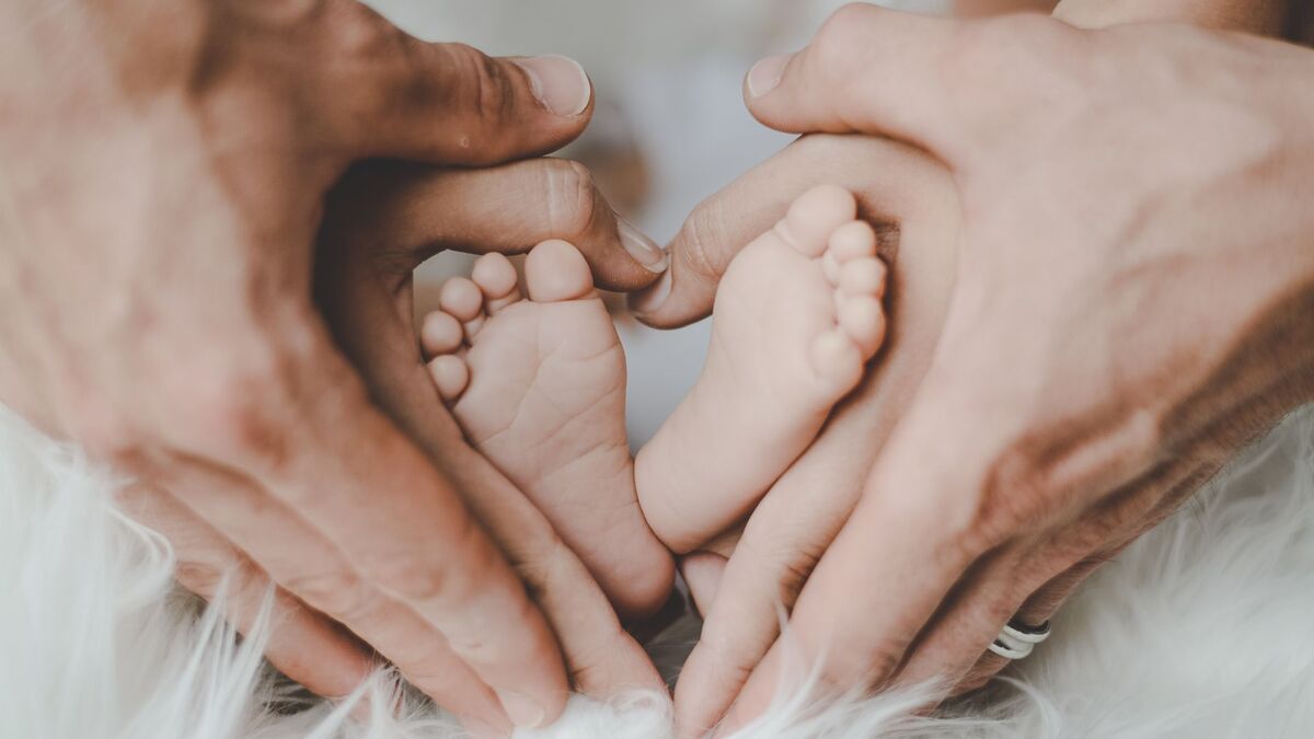 Hands holding baby feet